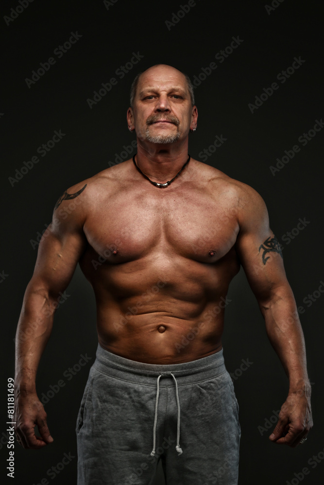 Muscular middle age man showing his muscules