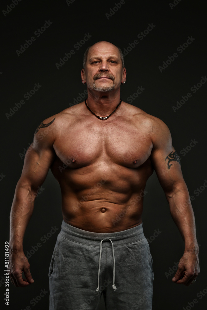Muscular middle age man showing his muscules Muscular middle age man showing his muscules