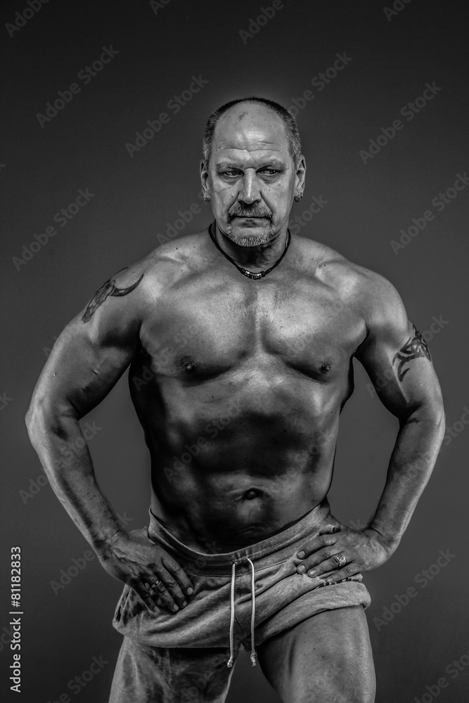 male with muscular body posing in studio male with muscular body posing in studio