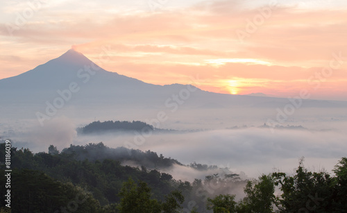 Colorful sunrise with Merapi volcanoand Borobudur temple