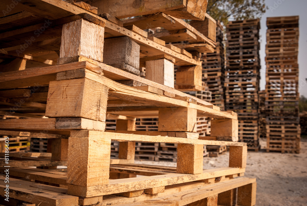 Wooden transport pallets in stacks. 