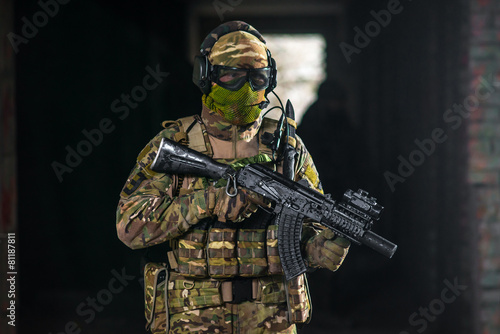 Airsoft strikeball player in military soilder uniform
