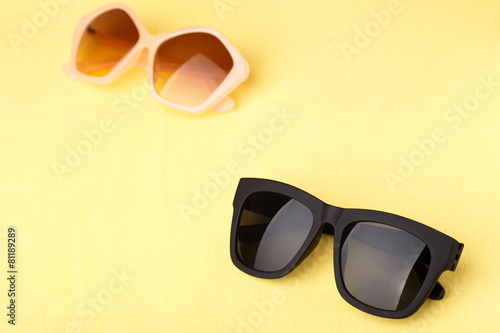 sunglasses on yellow wooden table