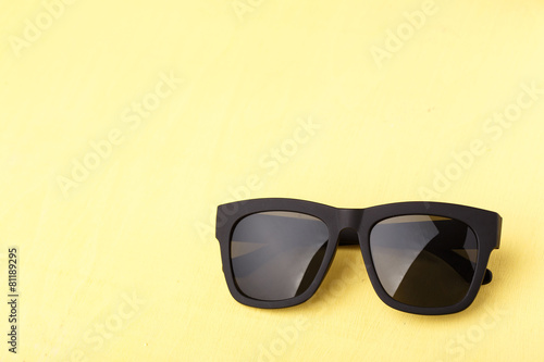 sunglasses on yellow wooden table
