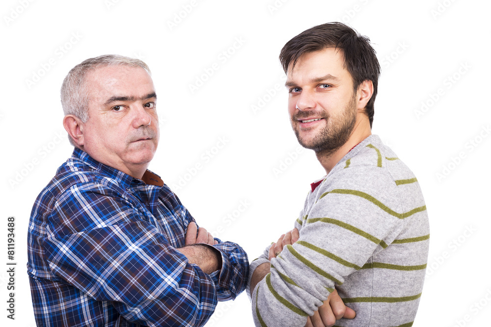 Portrait of two men, father and son, standing with arms folded a Portrait of two men, father and son, standing with arms folded a