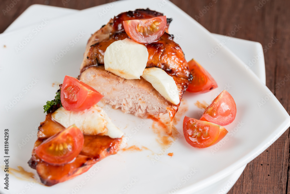 Grilled chicken steak with mozzarella and cherry tomatoes Grilled chicken steak with mozzarella and cherry tomatoes