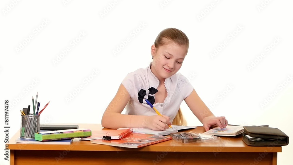 School girl doing her homework thinking about the topic of essay School girl doing her homework thinking about the topic of essay