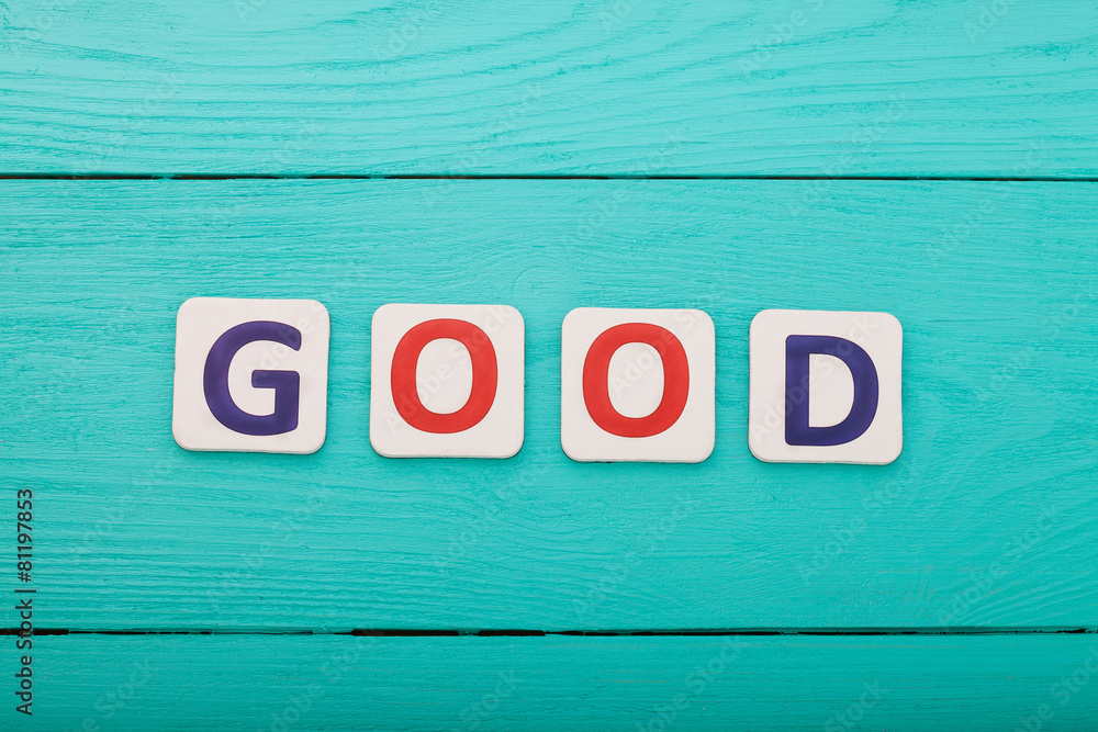 Word good on blue wooden background Word good on blue wooden background