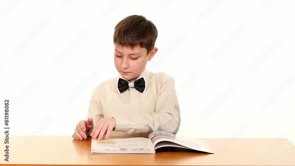 Little school boy looking for some information in the book, on Little school boy looking for some information in the book, on