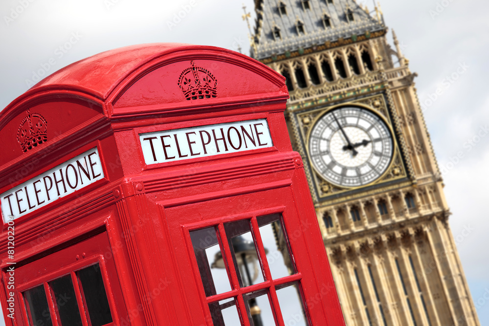 Obraz premium London red telephone box booth with westminster houses of parliament building and Big Ben clock tower in the background photo