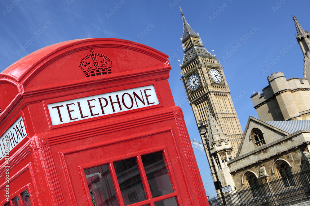 Obraz premium London red telephone box booth with westminster houses of parliament building and Big Ben clock tower in the background photo