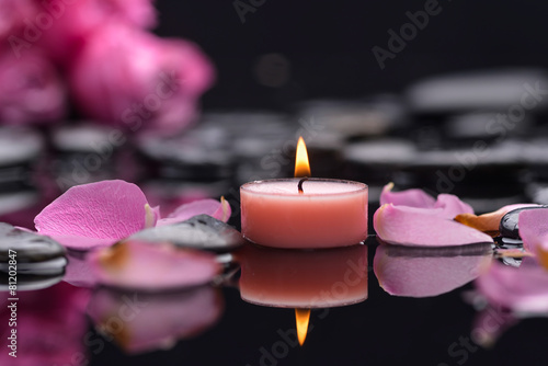 rose petals with candle and therapy stones  