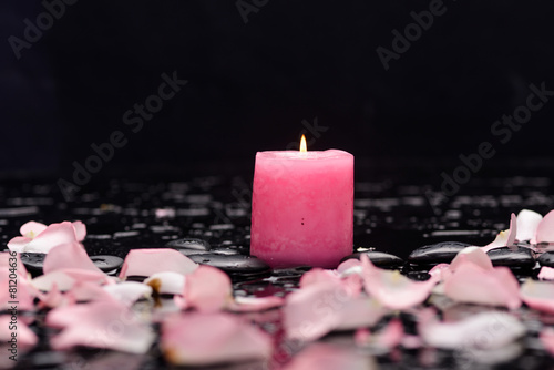 pink rose petals with pink candle and therapy stones 