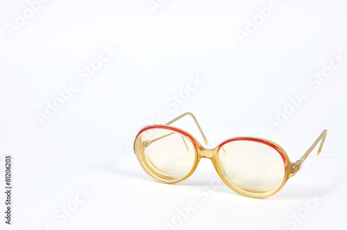 Red vintage eye-glasses on background.