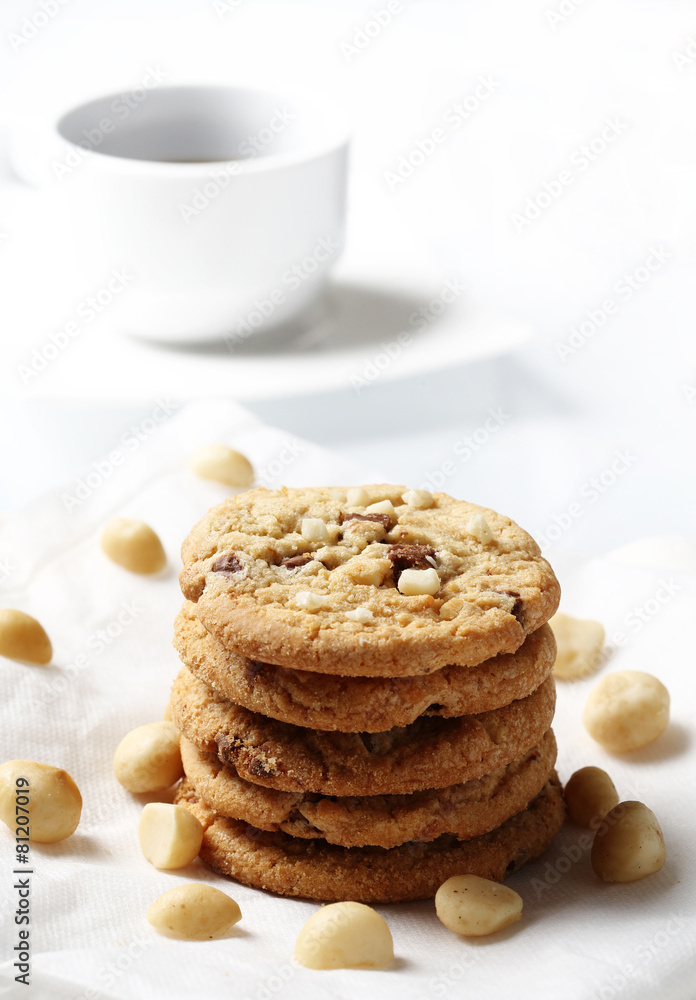 the chocolate and macadamia cookies on dish set for coffee break the chocolate and macadamia cookies on dish set for coffee break