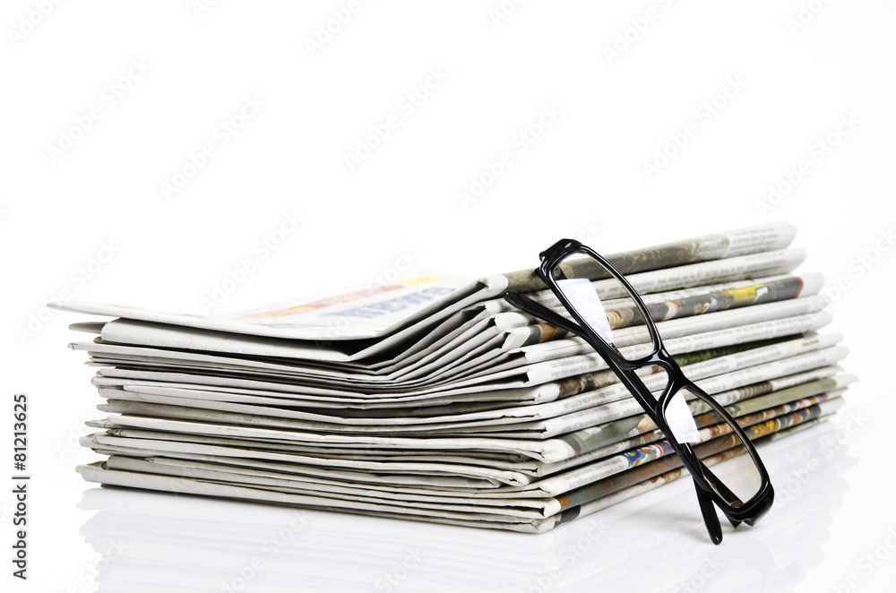glasses lean on newspapers against white background glasses lean on newspapers against white background
