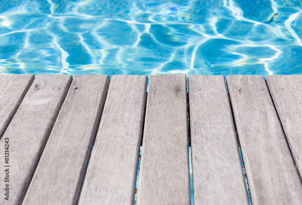 Empty wooden deck by the swimming pool