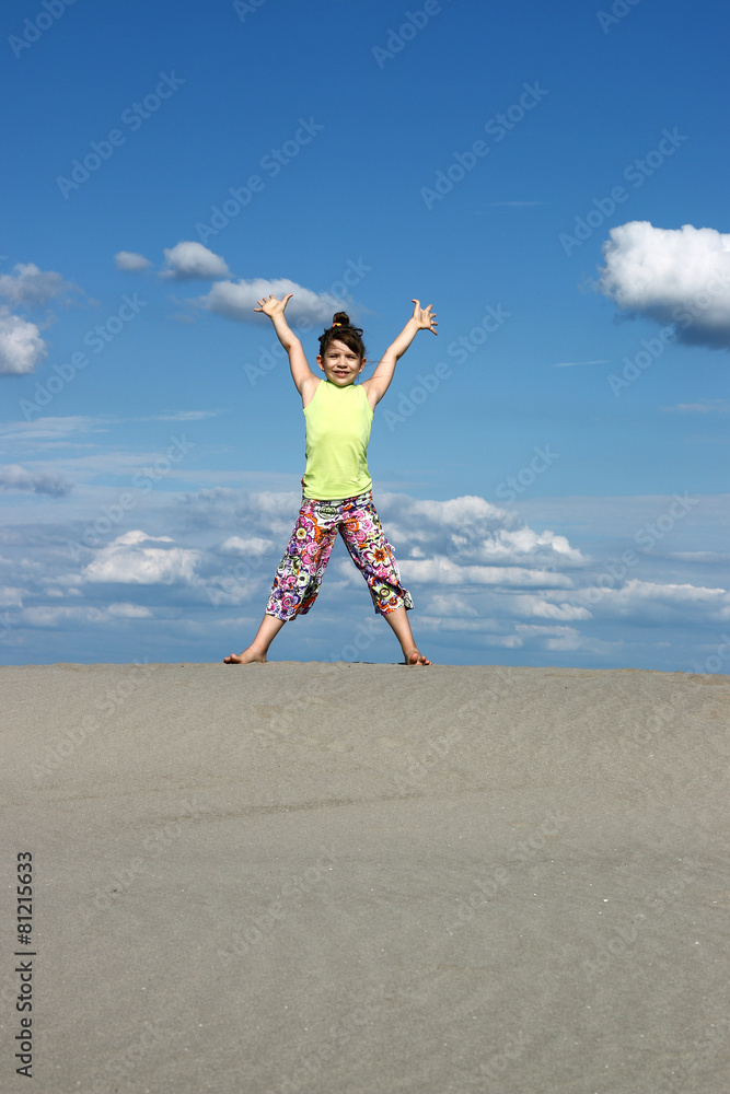 happy girl with raised hands on the beach