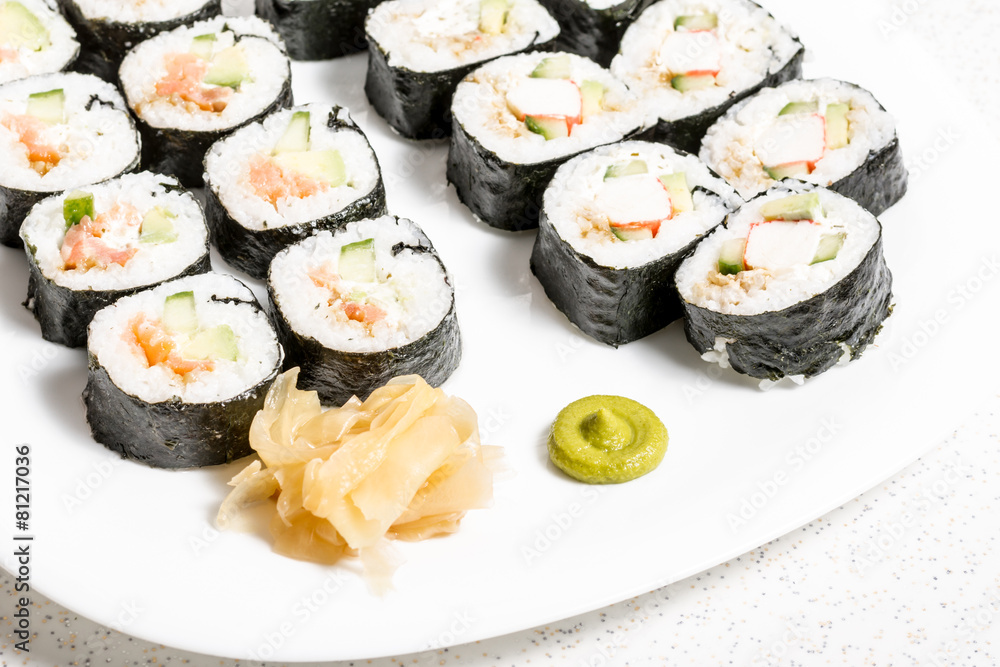 Homemade sushi in a white plate with wasabi and ginger Homemade sushi in a white plate with wasabi and ginger