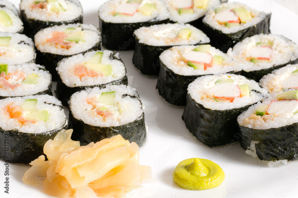 Homemade sushi in a white plate with wasabi and ginger Homemade sushi in a white plate with wasabi and ginger
