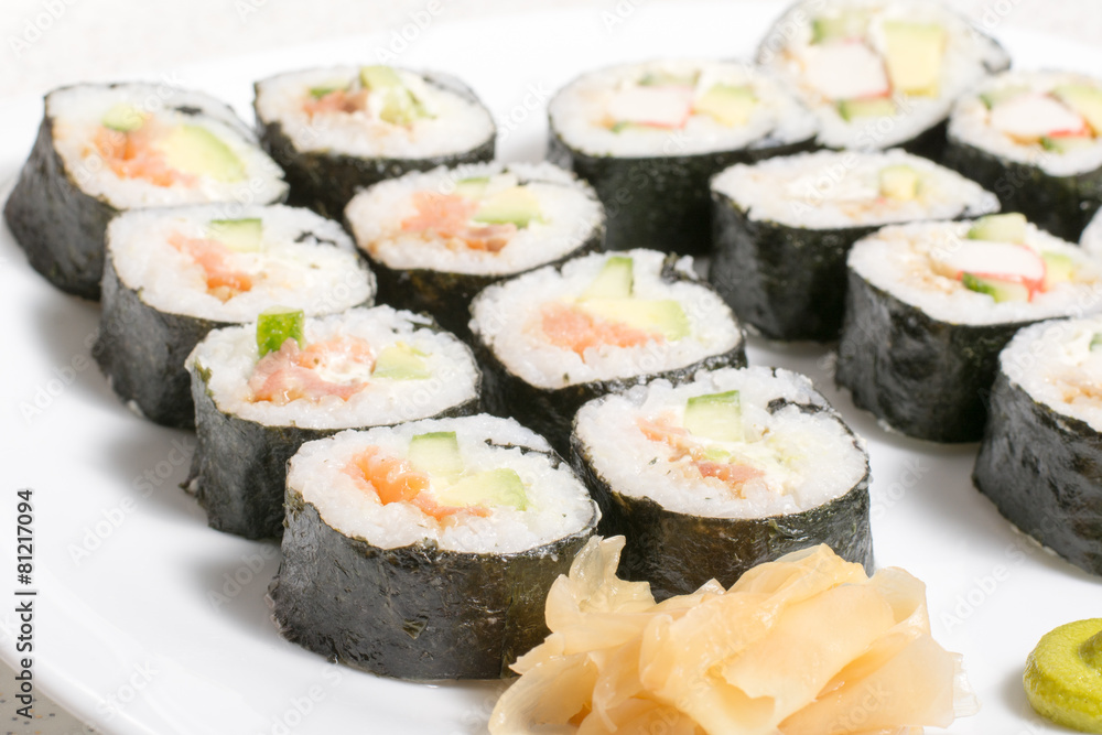 Homemade sushi in a white plate with wasabi and ginger Homemade sushi in a white plate with wasabi and ginger
