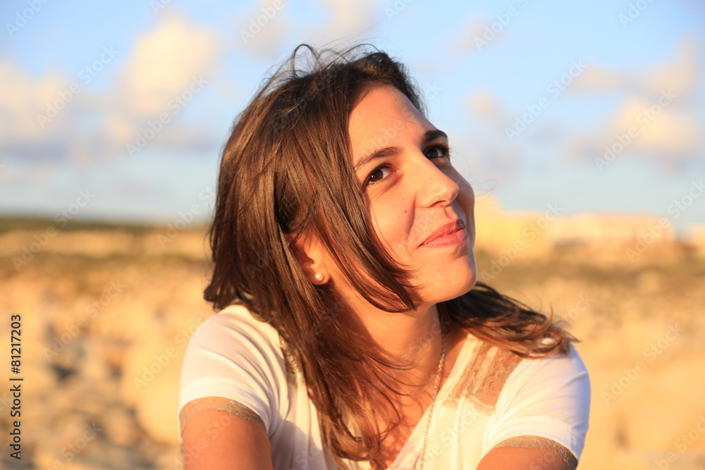 Smiling young (25-30) Sicilian girl near the beach at sunset.  
