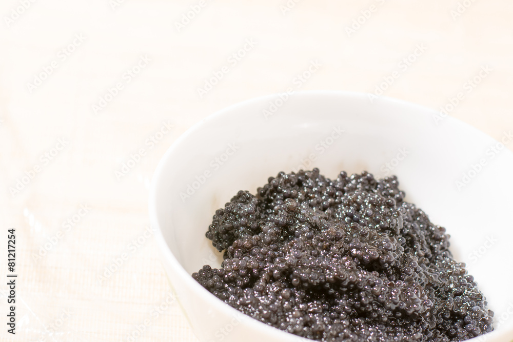 Fresh black caviar in a bowl to make sushi and fish dishes Fresh black caviar in a bowl to make sushi and fish dishes