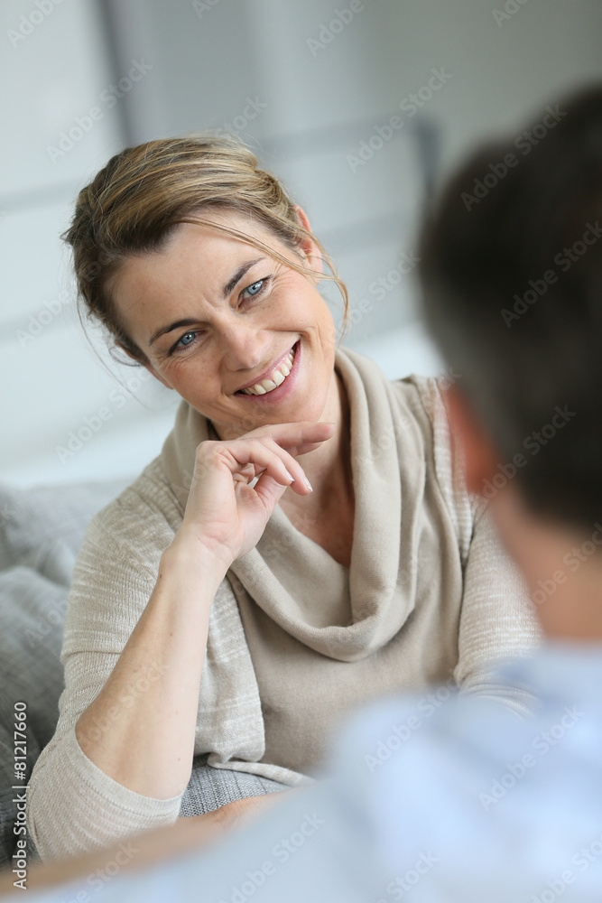 Couple at home sitting in sofa and having a talk