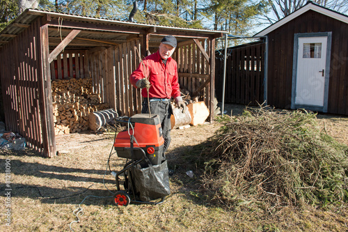 Man working with an electric chipper shredder 4 photo