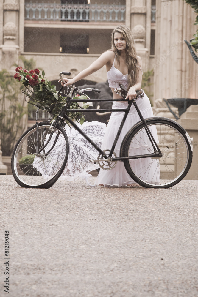 Fototapeta premium Young attractive woman outdoors with vintage bicycle