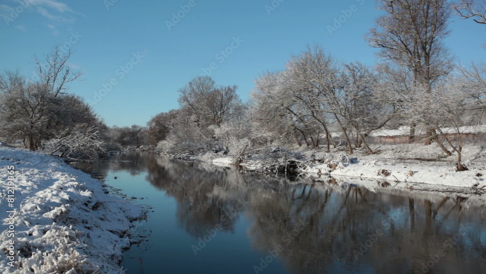 Winter landscape with the river and trees ashore in a sunny day Winter landscape with the river and trees ashore in a sunny day