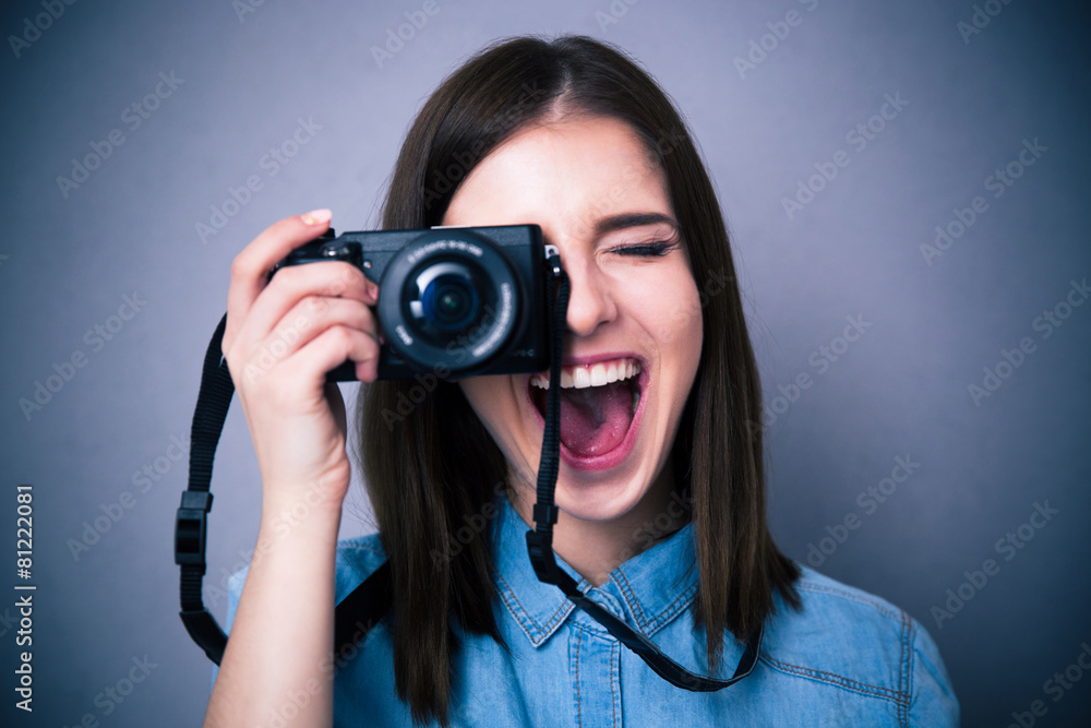 Cheerful young woman making photo on camera Cheerful young woman making photo on camera