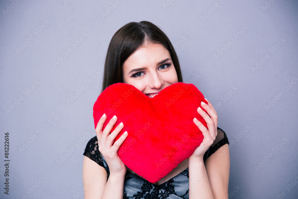 Happy beautiful woman holding red heart Happy beautiful woman holding red heart