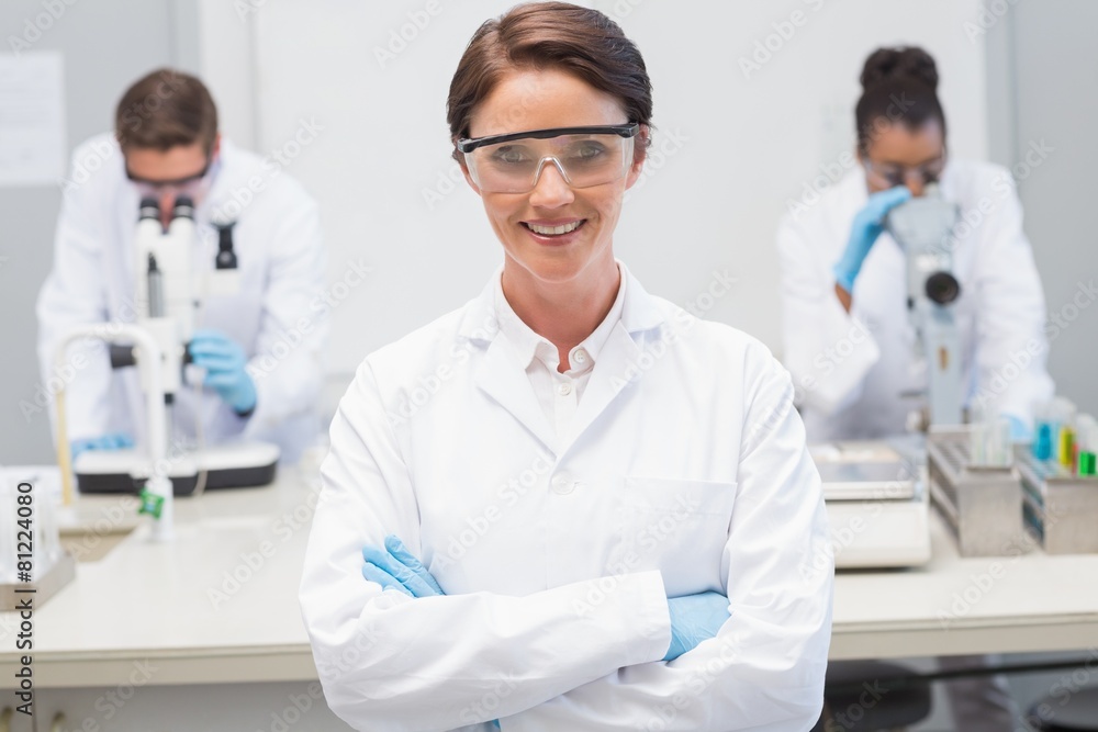 Happy scientist smiling at camera with protective glasses Happy scientist smiling at camera with protective glasses