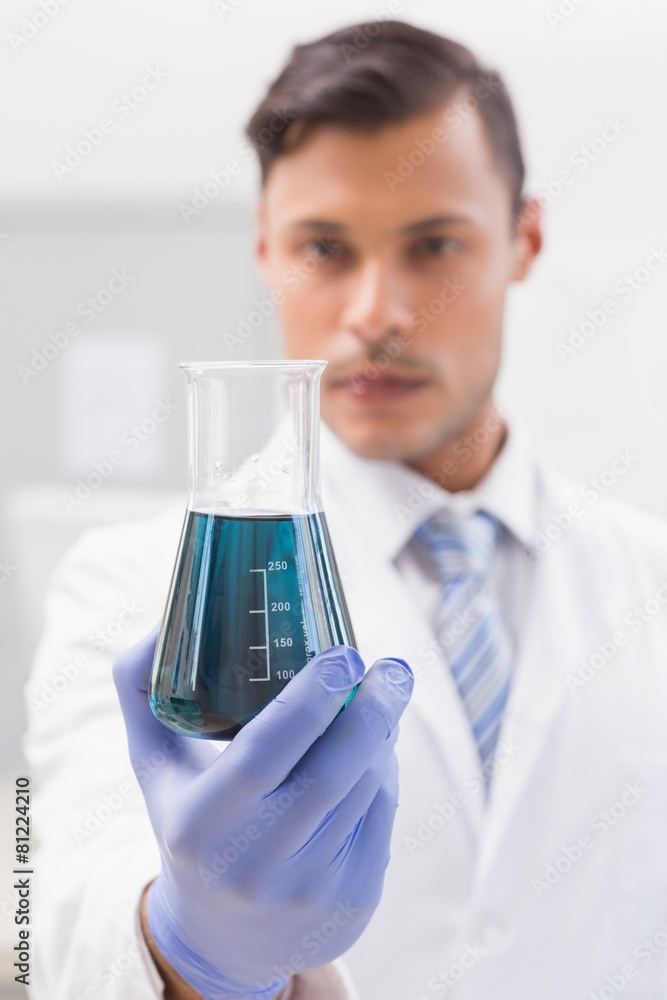Concentrated scientist looking at beaker Concentrated scientist looking at beaker
