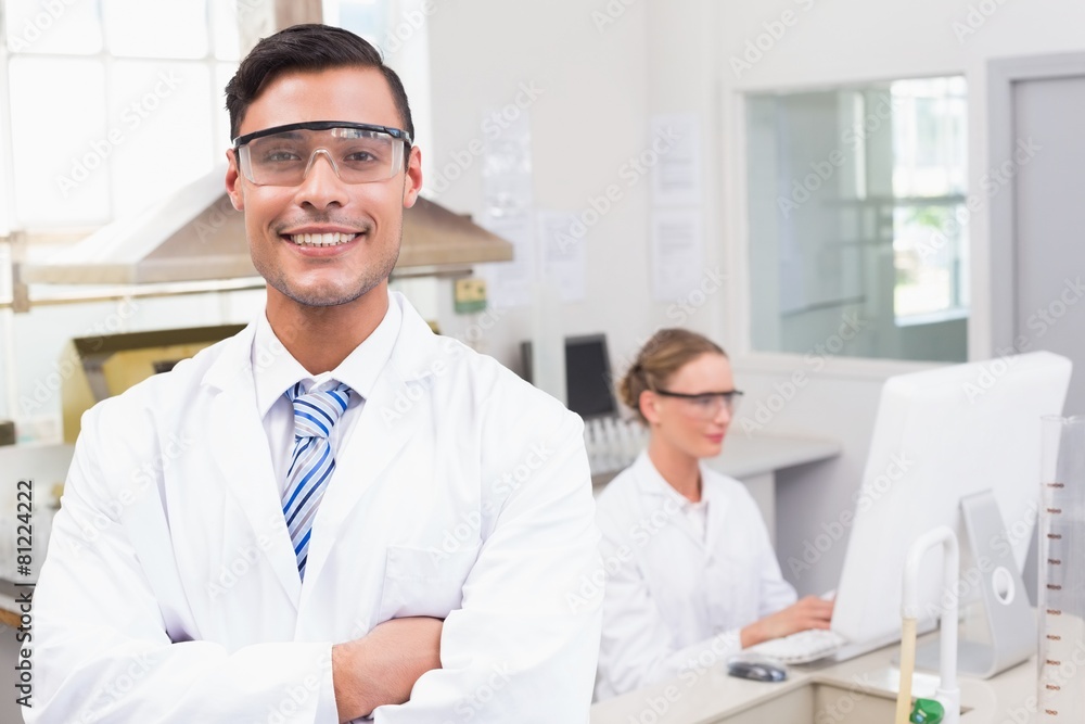 Smiling scientist looking at camera arms crossed Smiling scientist looking at camera arms crossed