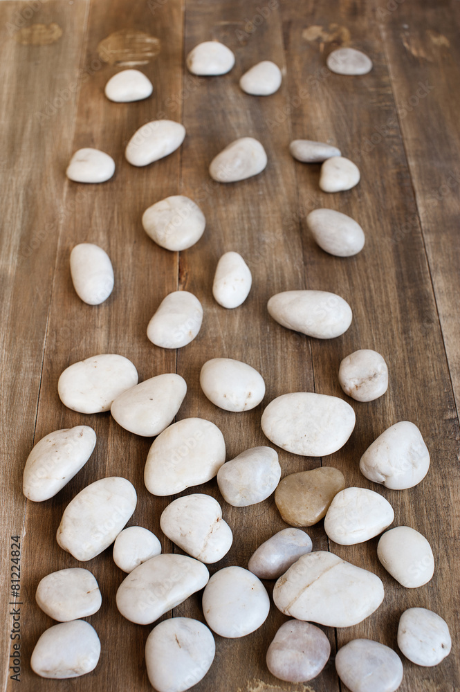Pebble on the distress wooden background
