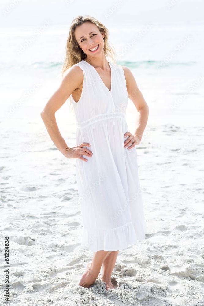Smiling blonde in white dress looking at camera