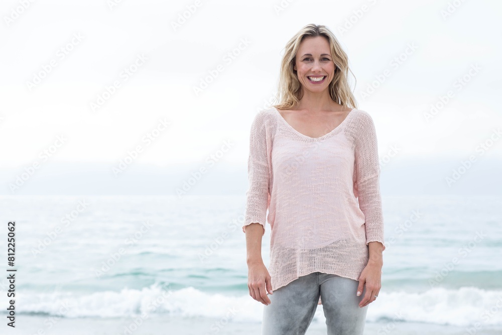 Smiling pretty blonde standing by the sea Smiling pretty blonde standing by the sea
