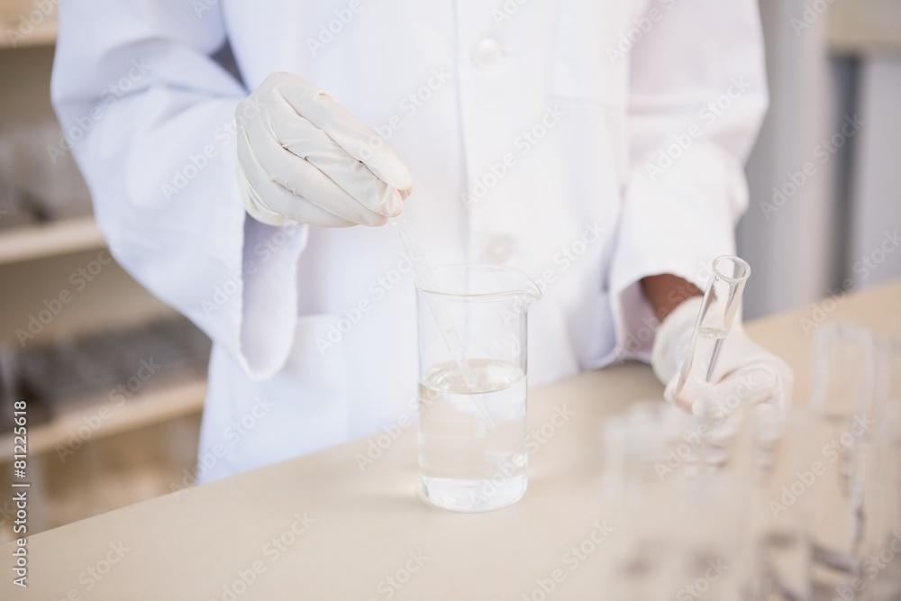 Scientist examining test tube and beaker Scientist examining test tube and beaker