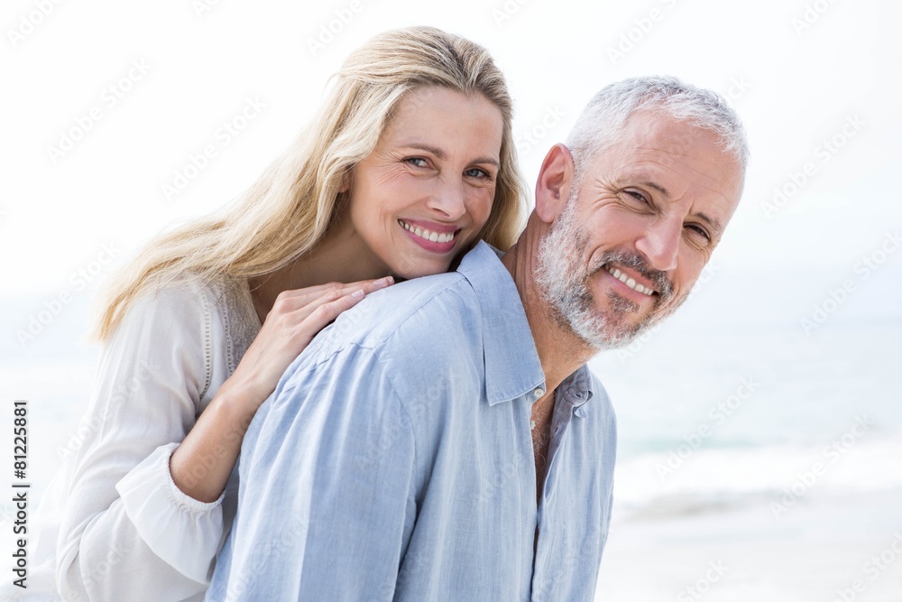 Happy couple hugging each other and smiling at camera Happy couple hugging each other and smiling at camera