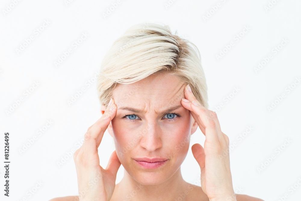 Pretty blonde suffering from headache looking at camera Pretty blonde suffering from headache looking at camera