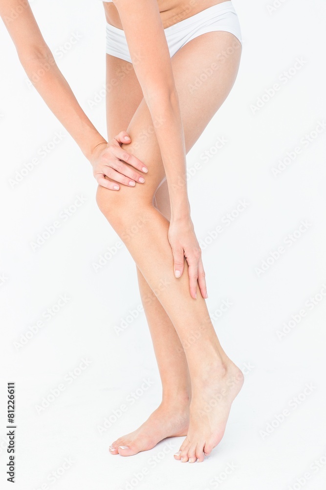 Attractive woman touching her leg Attractive woman touching her leg