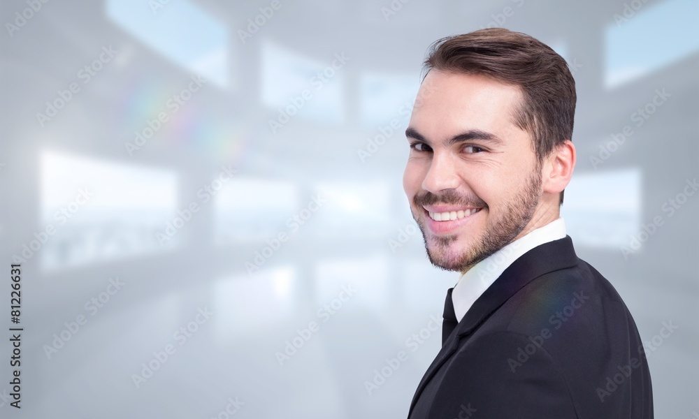 Composite image of elegant businessman in suit smiling at camera Composite image of elegant businessman in suit smiling at camera