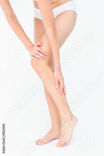 Attractive woman touching her leg