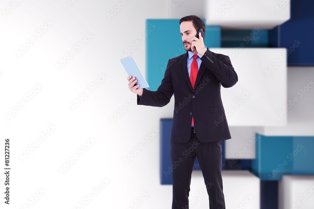Businessman talking on phone holding tablet Businessman talking on phone holding tablet