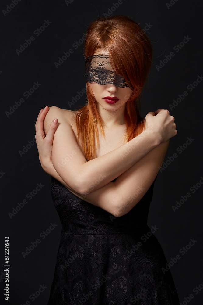 Fototapeta premium Red-haired beauty with lace mask on eyes