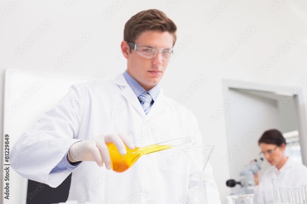 Scientists working attentively with test tube and microscope Scientists working attentively with test tube and microscope