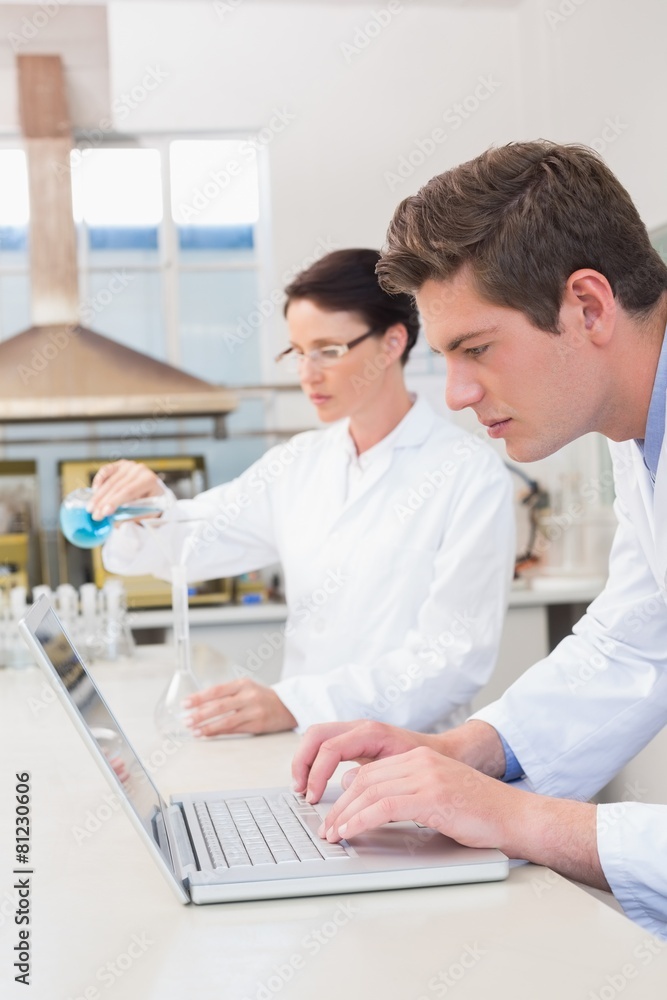 Scientist working attentively with laptop Scientist working attentively with laptop