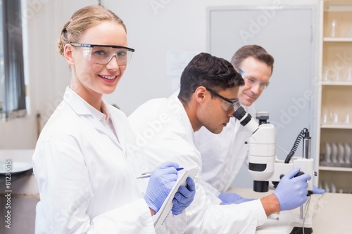 Smiling scientist looking at camera